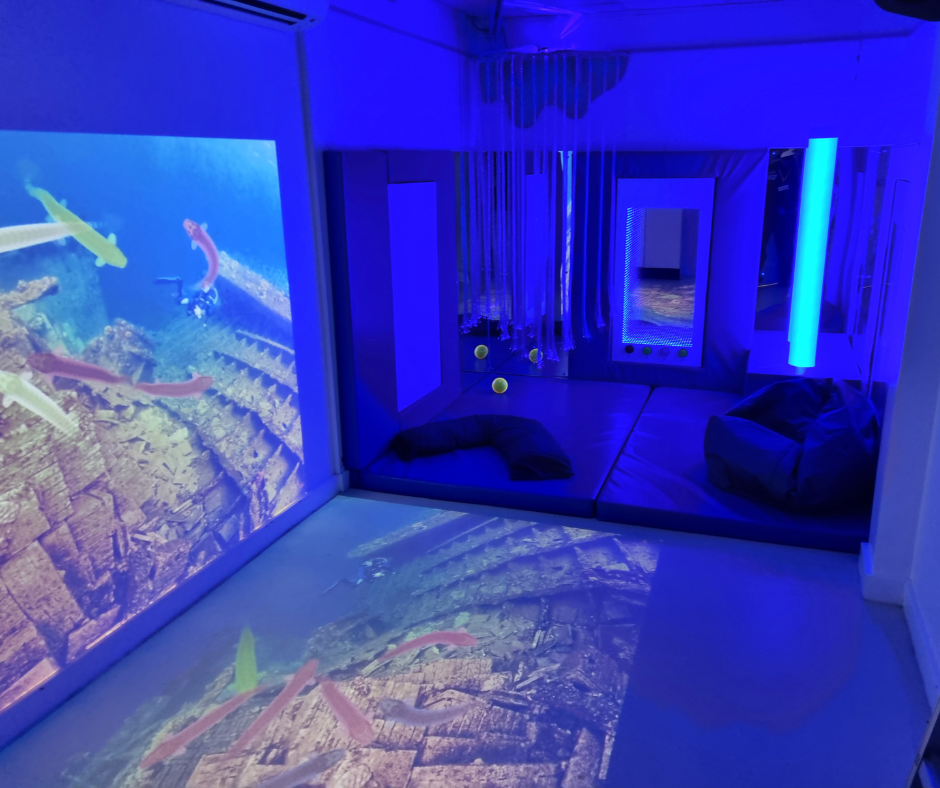 A sensory/immersive room from Integrex featuring a projection of fish swimming.