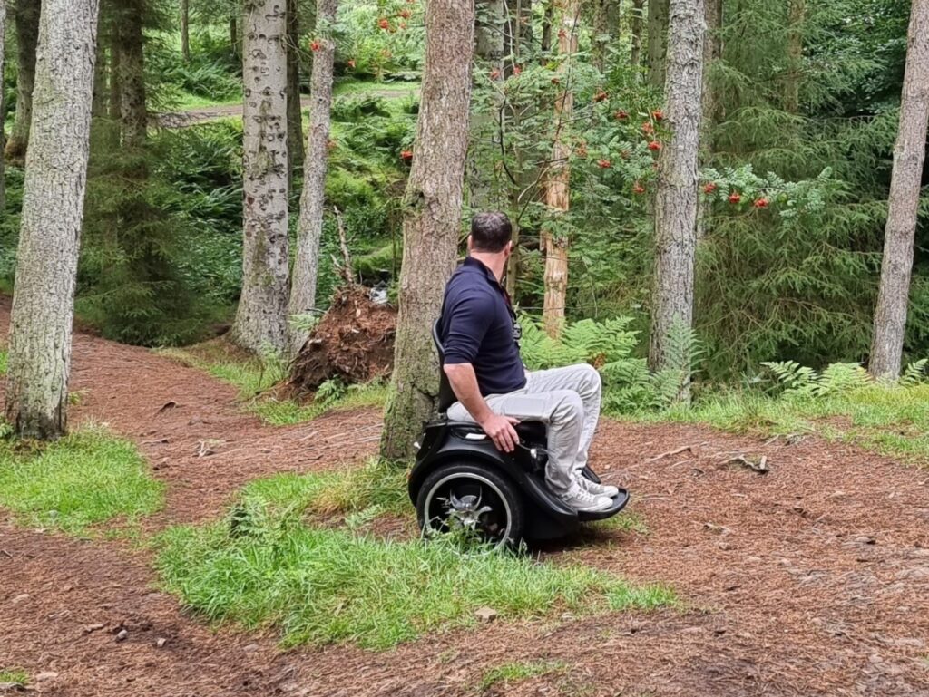 Adapt Ability Omeo Powerchair in woodland setting