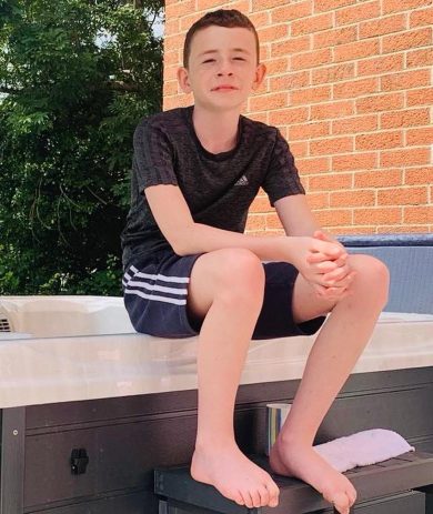 Iolo Edwards sitting on the edge of a hot tub.