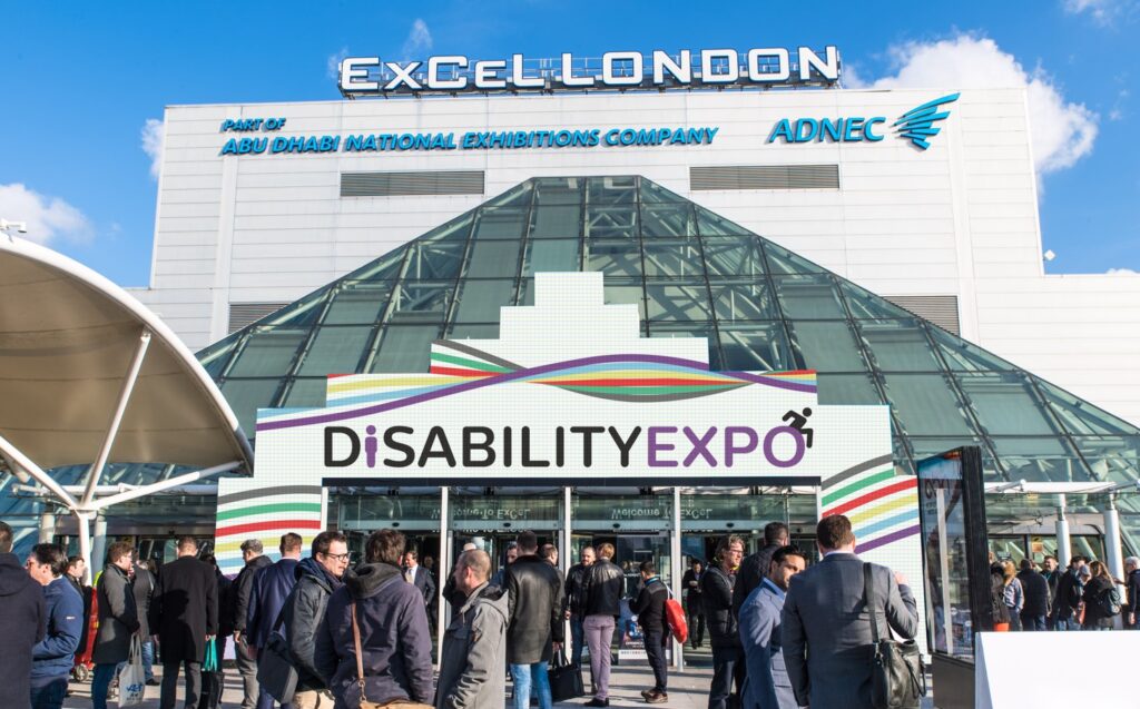 Exterior of ExCeL London main entrance, showing Disability Expo branding.